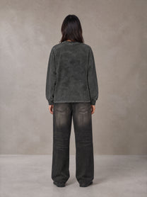 Model wearing the SM Acid Wash Long Sleeve T-shirt in Deep Charcoal, rear view.