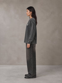 Model wearing the SM Acid Wash Long Sleeve T-shirt in Deep Charcoal, side profile.