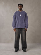 Model wearing the SM Acid Wash Long Sleeve T-shirt in Deep Purple, front view.