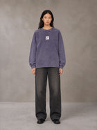 Model wearing the SM Acid Wash Long Sleeve T-shirt in Deep Purple, front view.