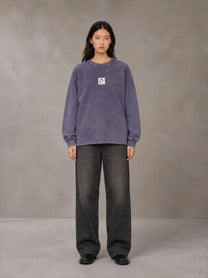 Model wearing the SM Acid Wash Long Sleeve T-shirt in Deep Purple, front view.