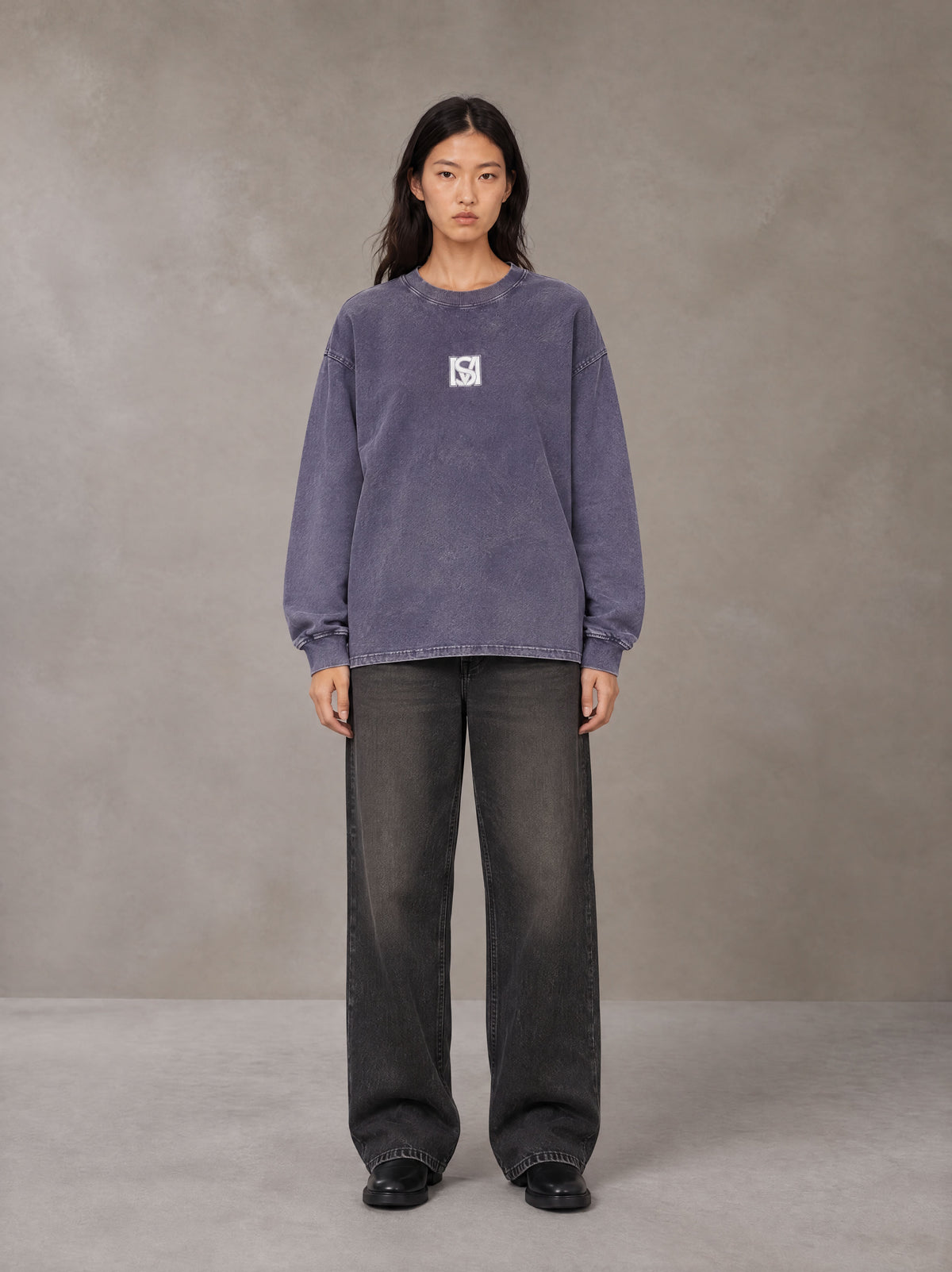 Model wearing the SM Acid Wash Long Sleeve T-shirt in Deep Purple, front view.
