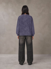 Model wearing the SM Acid Wash Long Sleeve T-shirt in Deep Purple, rear view.