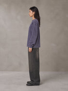 Model wearing the SM Acid Wash Long Sleeve T-shirt in Deep Purple, side profile.