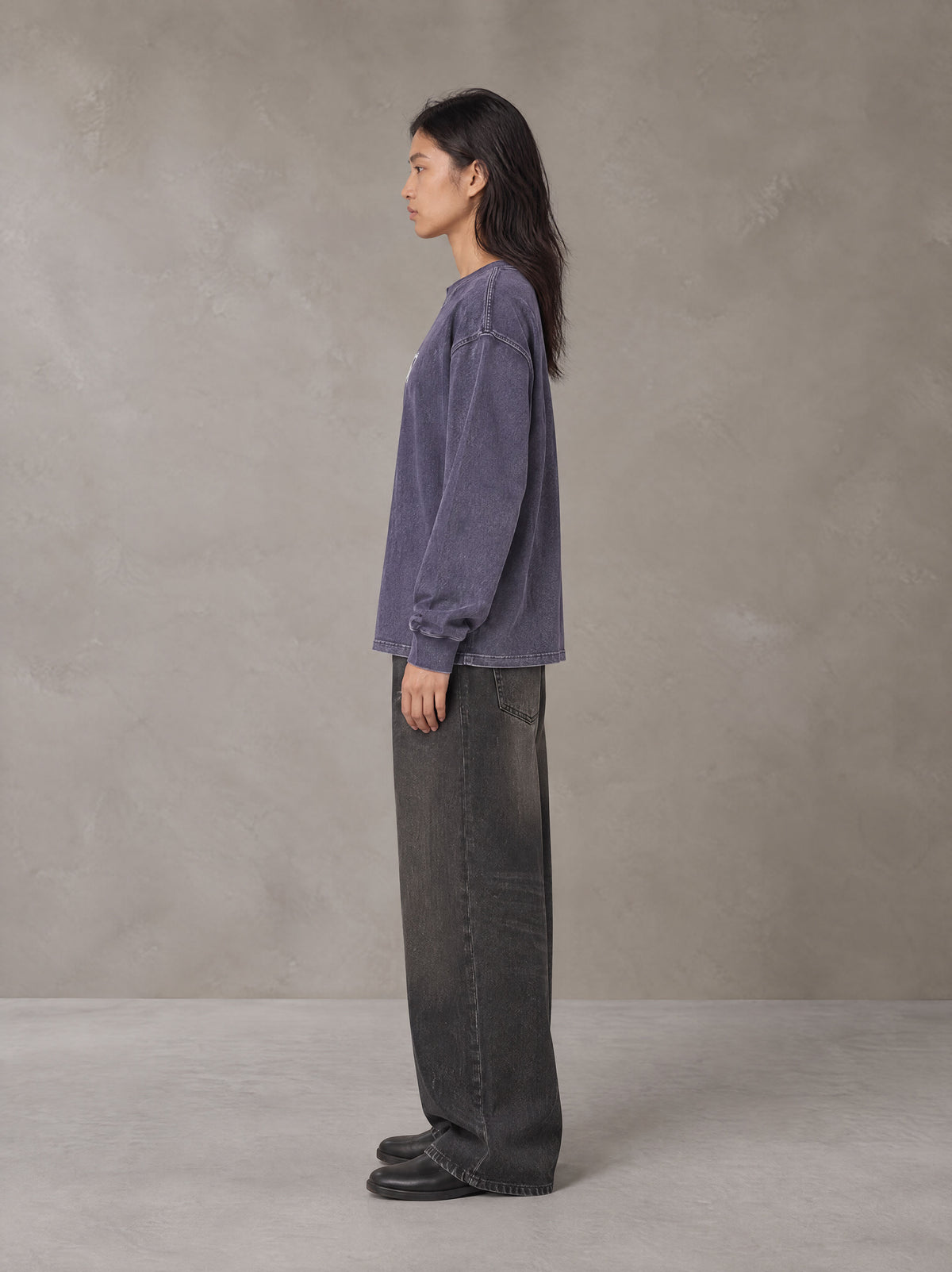 Model wearing the SM Acid Wash Long Sleeve T-shirt in Deep Purple, side profile.