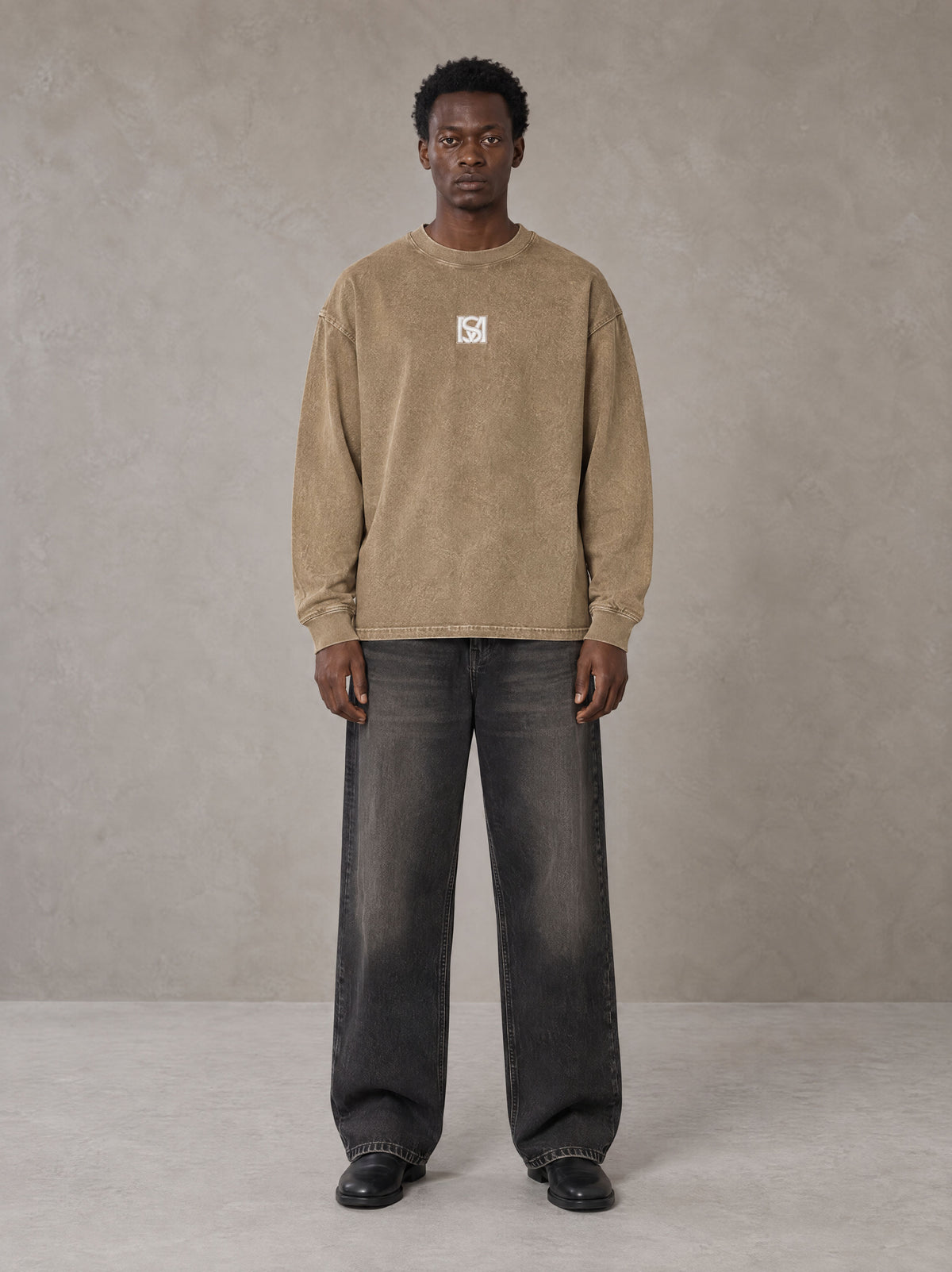 Model wearing the SM Acid Wash Long Sleeve T-shirt in Fine Sand, front view.
