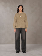 Model wearing the SM Acid Wash Long Sleeve T-shirt in Fine Sand, front view.