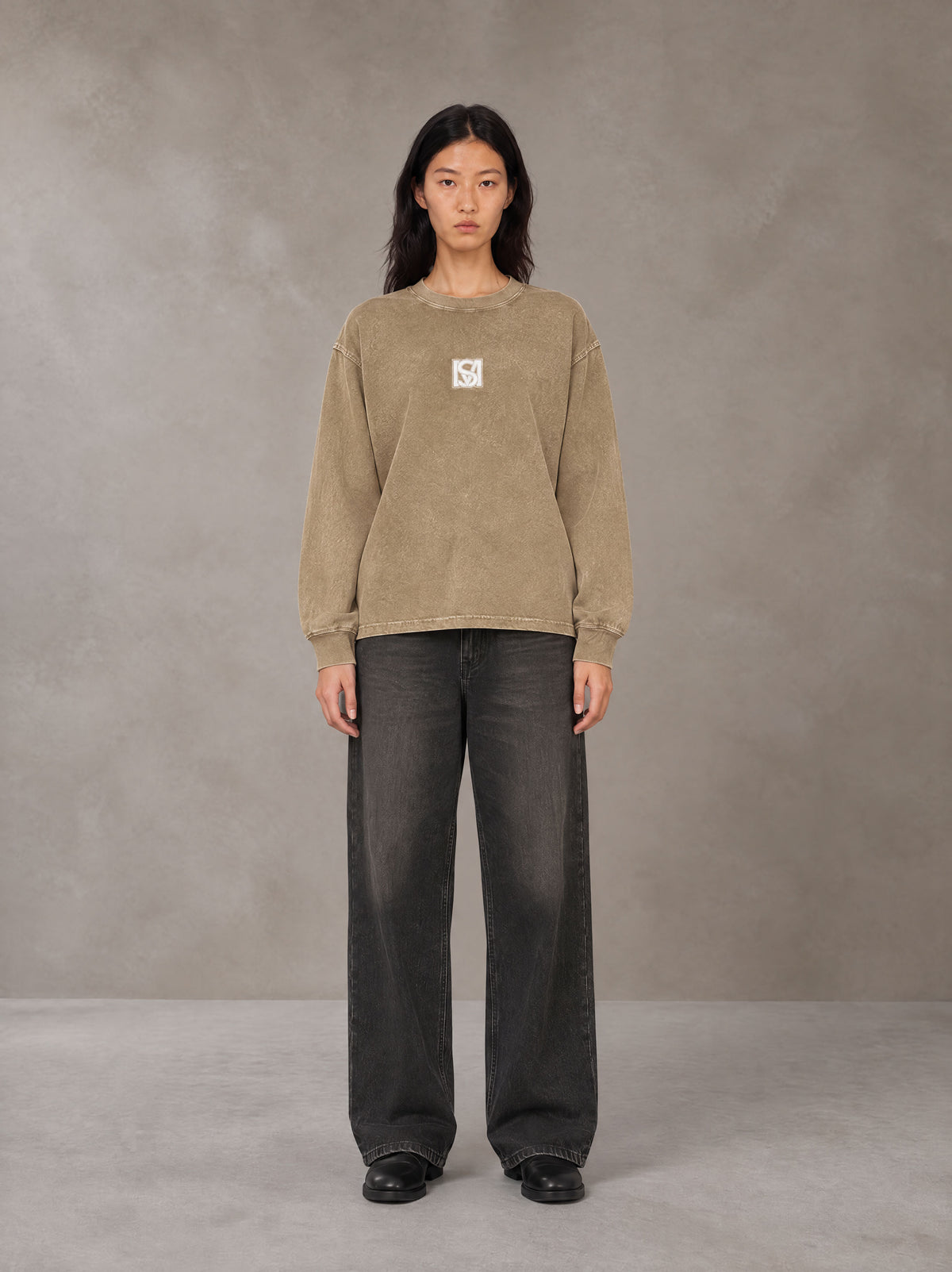 Model wearing the SM Acid Wash Long Sleeve T-shirt in Fine Sand, front view.