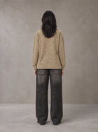 Model wearing the SM Acid Wash Long Sleeve T-shirt in Fine Sand, rear view.