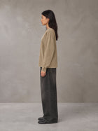 Model wearing the SM Acid Wash Long Sleeve T-shirt in Fine Sand, side profile.