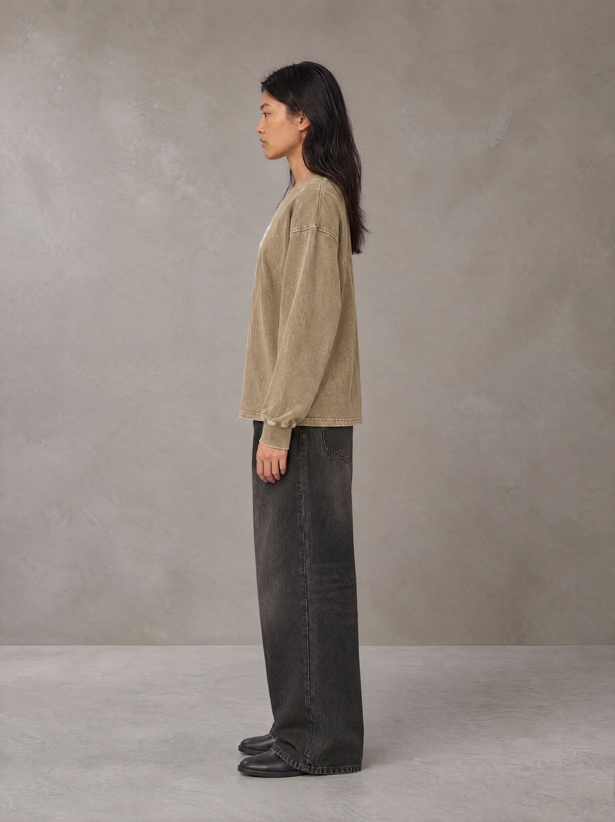 Model wearing the SM Acid Wash Long Sleeve T-shirt in Fine Sand, side profile.