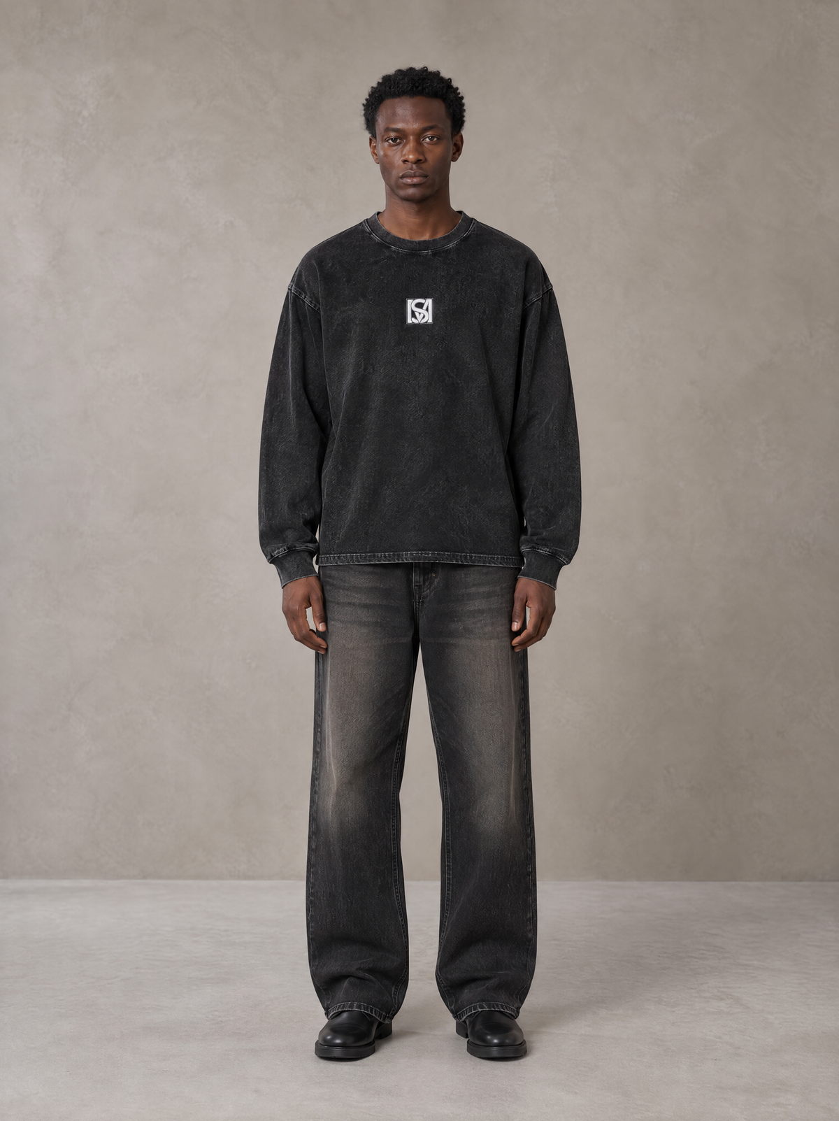 Model wearing the SM Acid Wash Long Sleeve T-shirt in Midnight Black, front view.