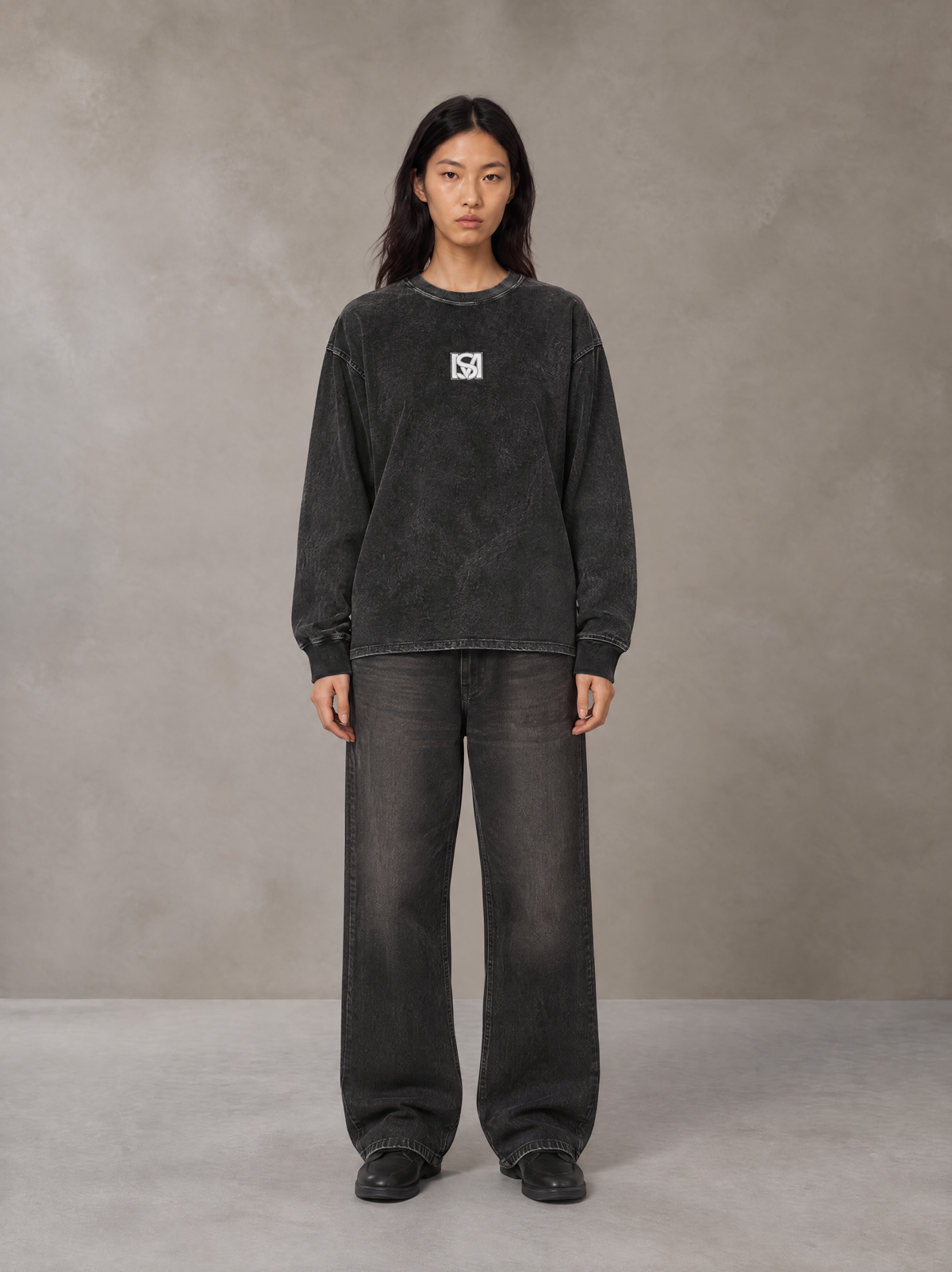 Model wearing the SM Acid Wash Long Sleeve T-shirt in Midnight Black, front view.
