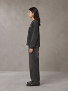 Model wearing the SM Acid Wash Long Sleeve T-shirt in Midnight Black, side profile.