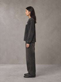 Model wearing the SM Acid Wash Long Sleeve T-shirt in Midnight Black, side profile.