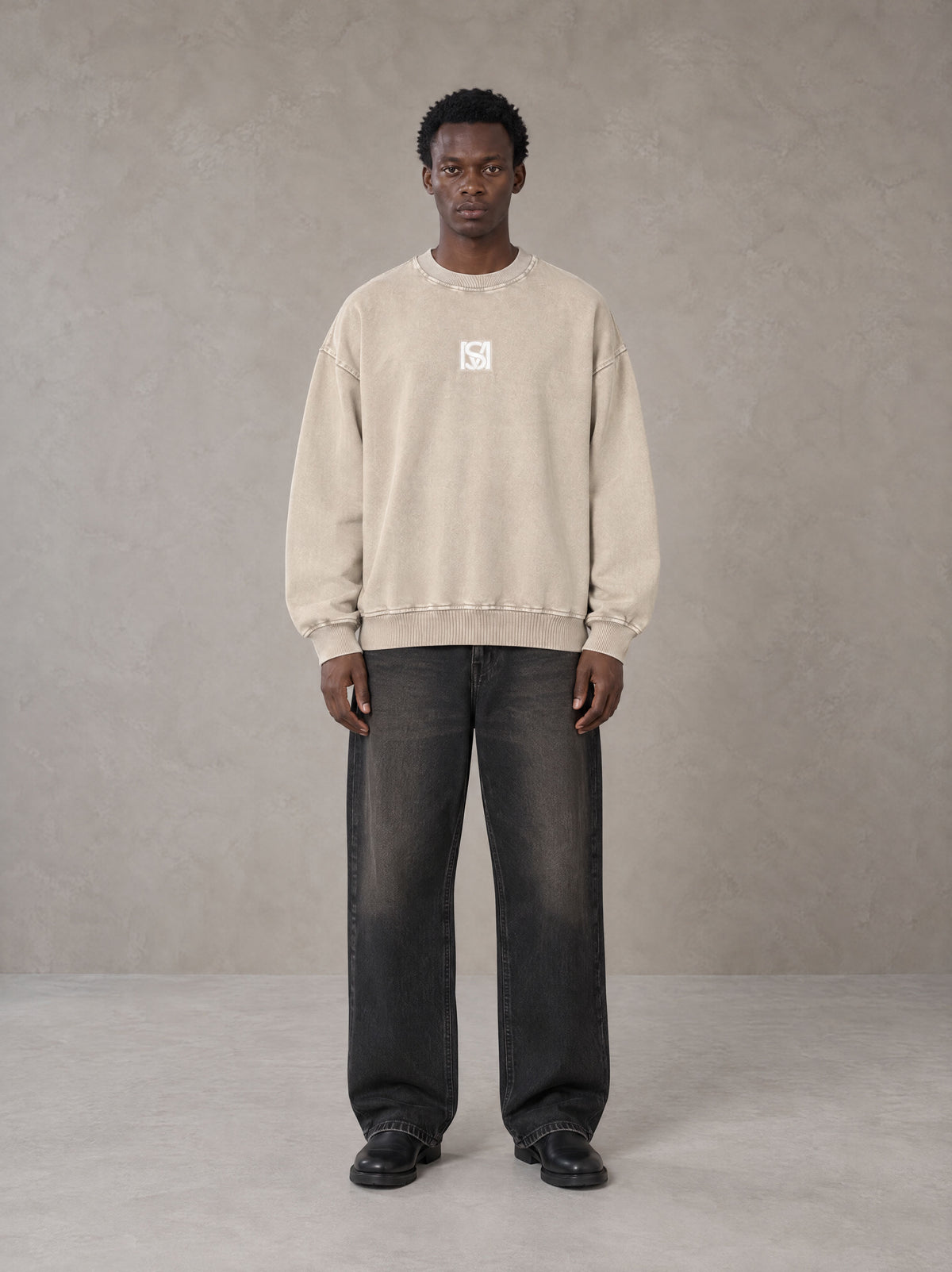 Model wearing the SM Acid Wash Sweatshirt in Apricot Tint, front view.