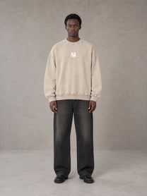 Model wearing the SM Acid Wash Sweatshirt in Apricot Tint, front view.