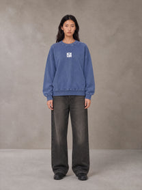 Model wearing the SM Acid Wash Sweatshirt in Classic Blue, front view.