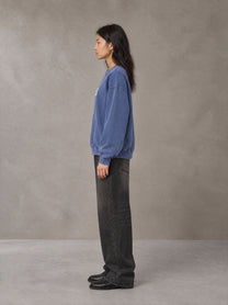 Model wearing the SM Acid Wash Sweatshirt in Classic Blue, side profile.