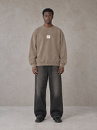 Model wearing the SM Acid Wash Sweatshirt in Coffee Grey, front view.