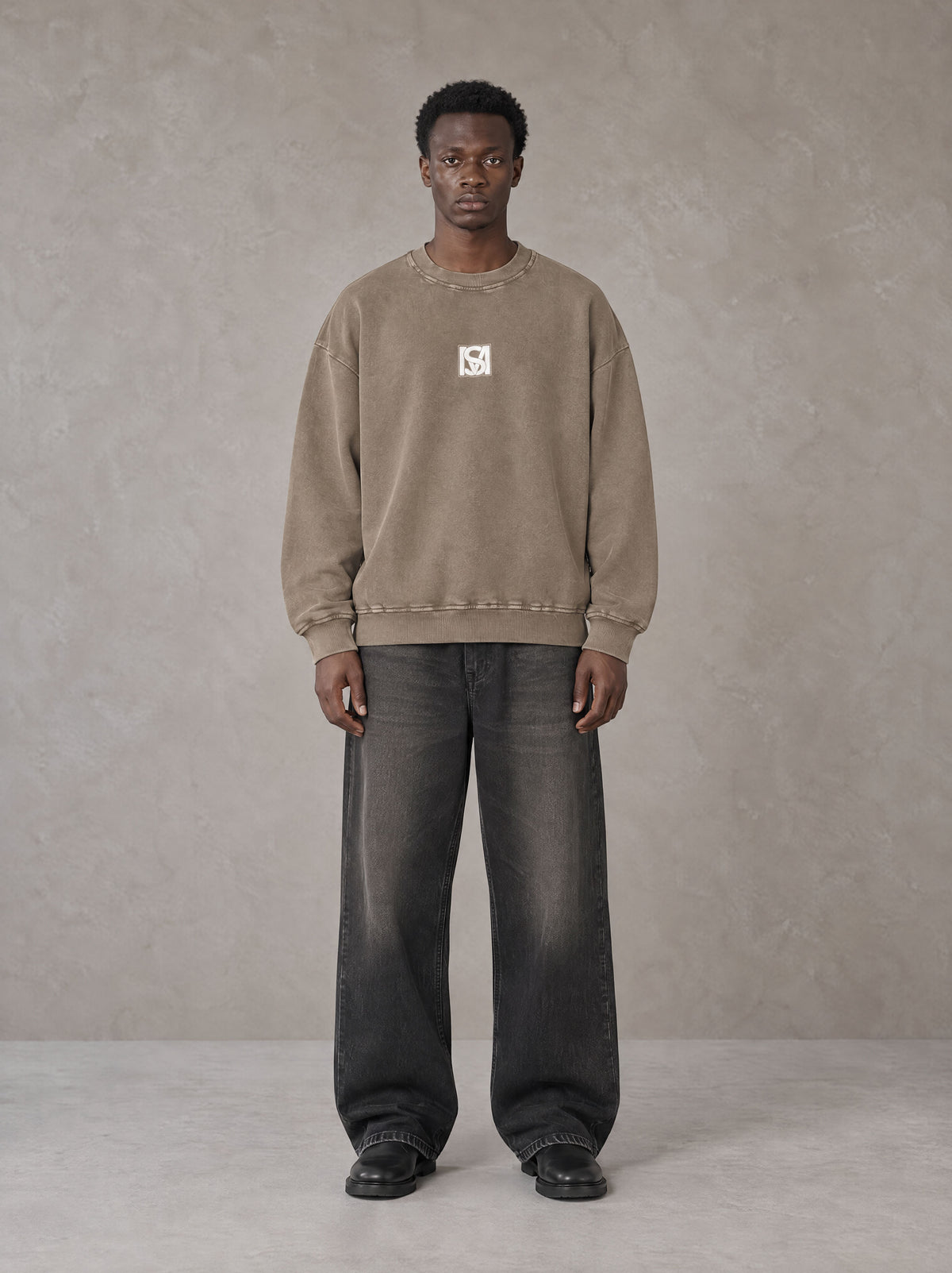 Model wearing the SM Acid Wash Sweatshirt in Coffee Grey, front view.
