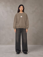 Model wearing the SM Acid Wash Sweatshirt in Coffee Grey, front view.