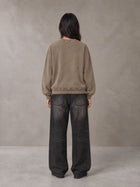 Model wearing the SM Acid Wash Sweatshirt in Coffee Grey, rear view.