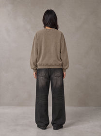 Model wearing the SM Acid Wash Sweatshirt in Coffee Grey, rear view.