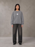 Model wearing the SM Acid Wash Sweatshirt in Pure Grey, front view.