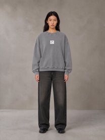 Model wearing the SM Acid Wash Sweatshirt in Pure Grey, front view.