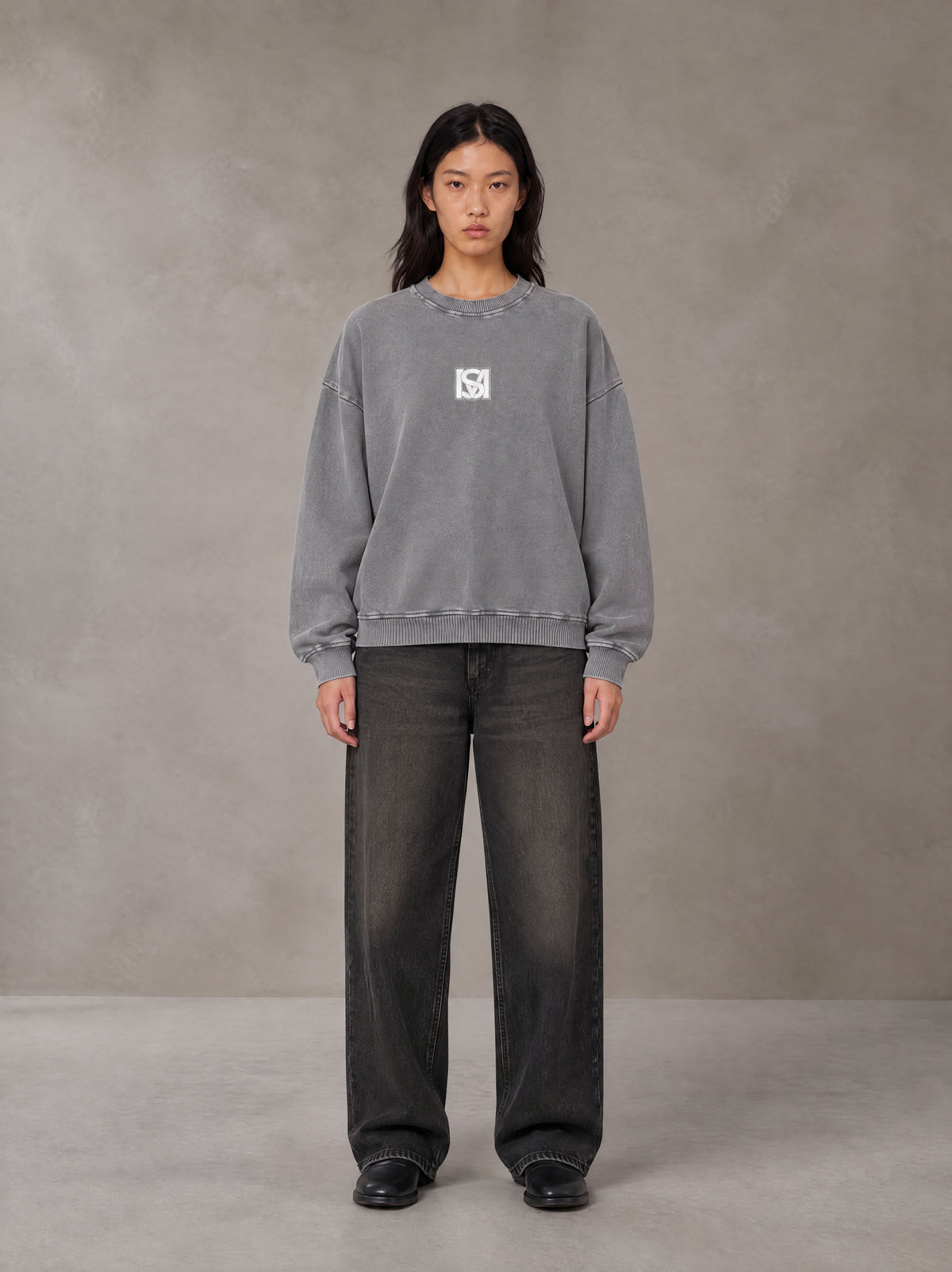 Model wearing the SM Acid Wash Sweatshirt in Pure Grey, front view.