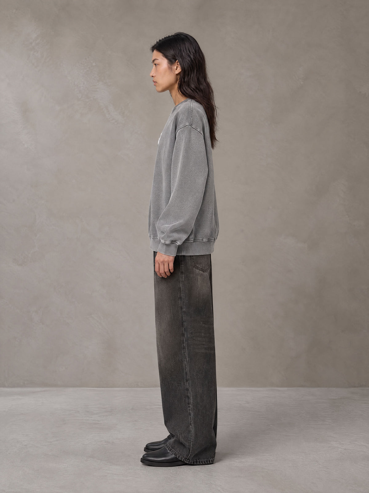 Model wearing the SM Acid Wash Sweatshirt in Pure Grey, side profile.