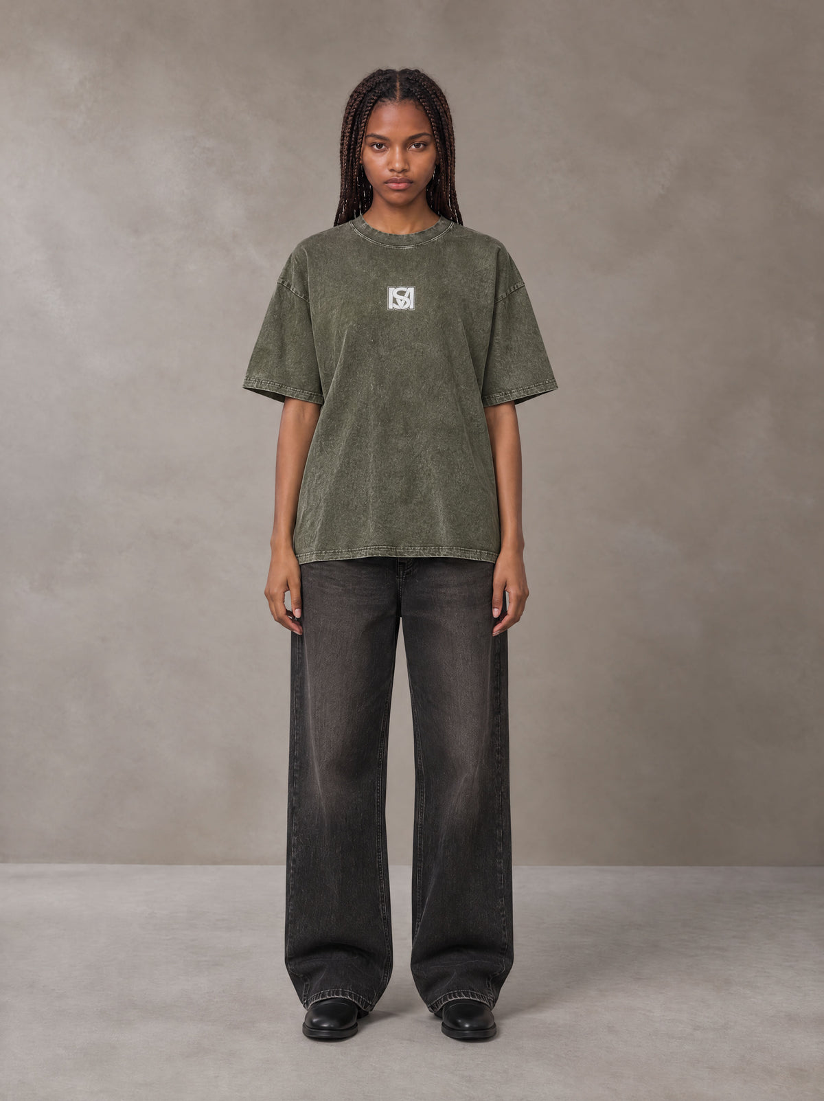 Model wearing the SM Acid Wash T-shirt in Alpine Green, front view.