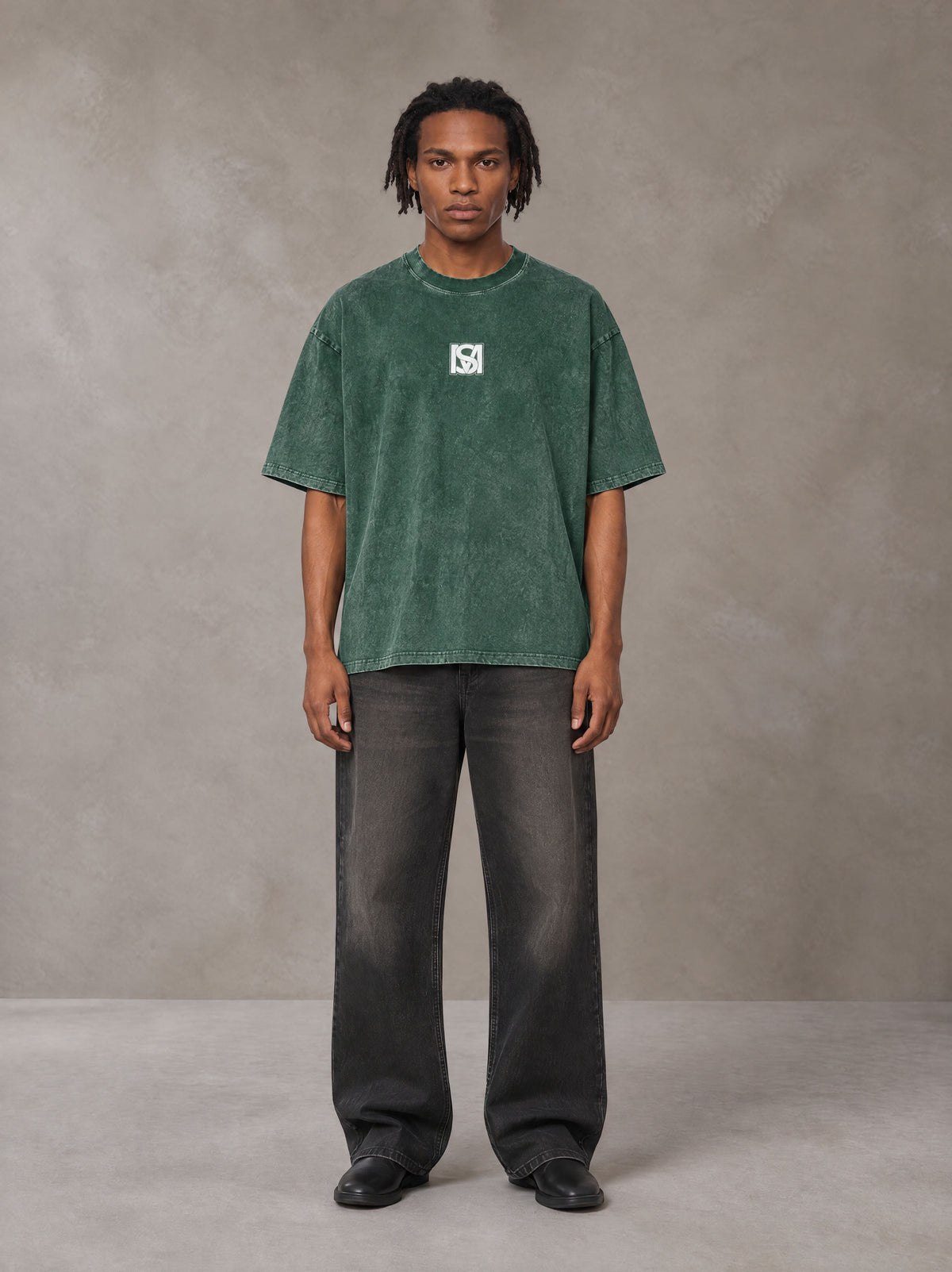 Model wearing the SM Acid Wash T-shirt in Dark Green, front view.