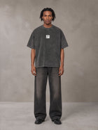 Model wearing the SM Acid Wash T-shirt in Deep Charcoal, front view.