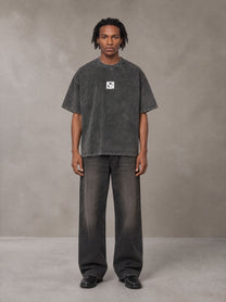 Model wearing the SM Acid Wash T-shirt in Deep Charcoal, front view.