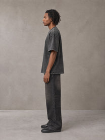 Model wearing the SM Acid Wash T-shirt in Deep Charcoal, side profile.