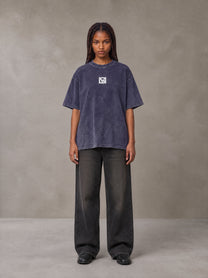 Model wearing the SM Acid Wash T-shirt in Deep Purple, front view.