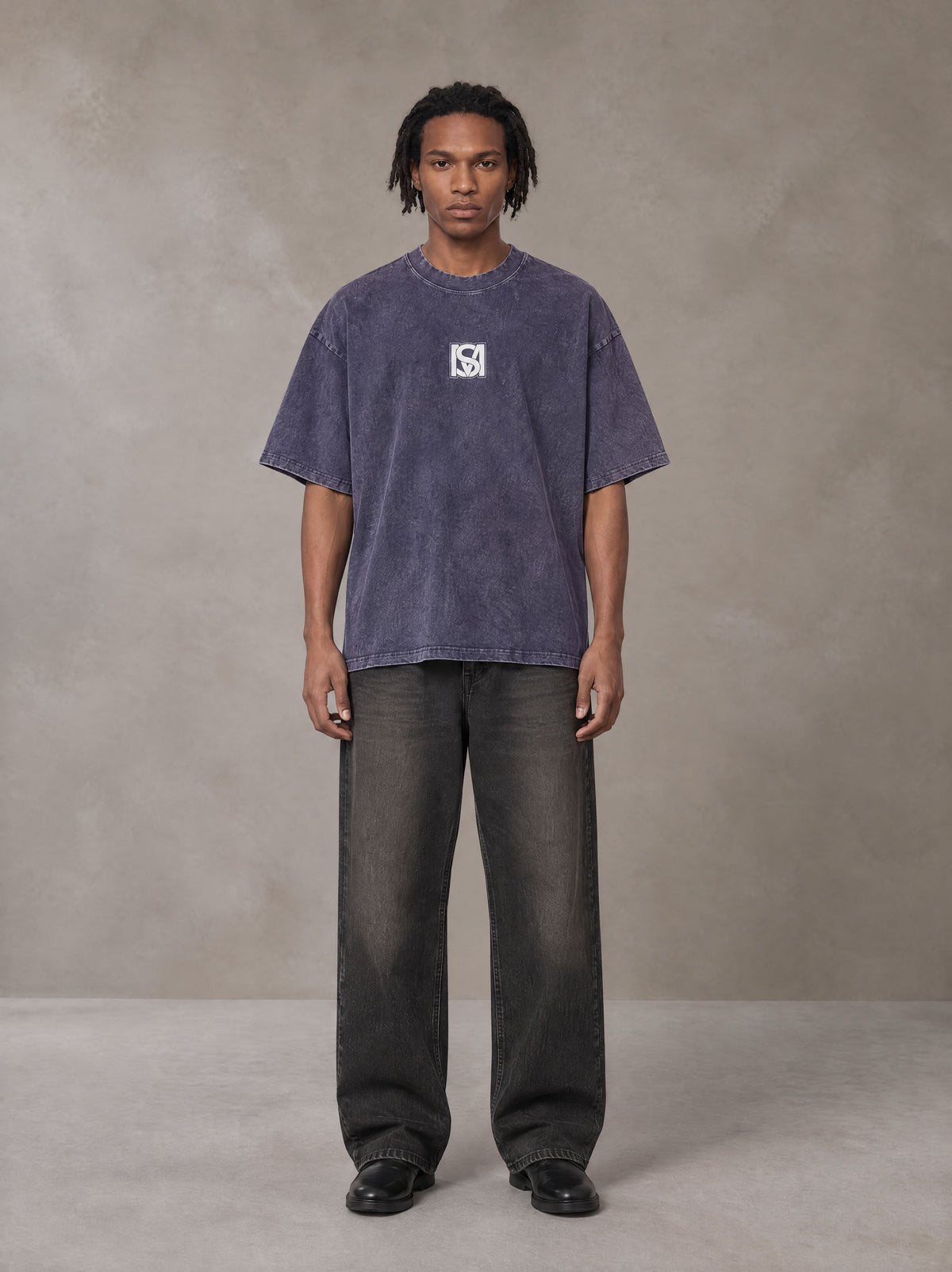 Model wearing the SM Acid Wash T-shirt in Deep Purple, front view.