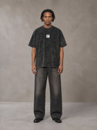 Model wearing the SM Acid Wash T-shirt in Midnight Black, front view.