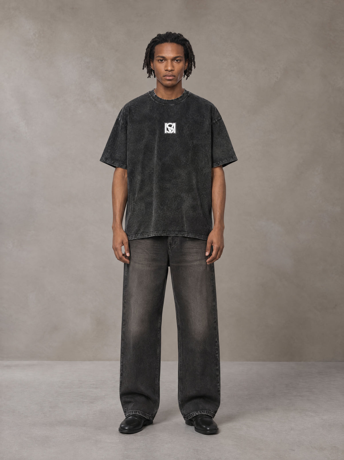 Model wearing the SM Acid Wash T-shirt in Midnight Black, front view.