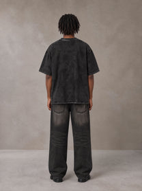Model wearing the SM Acid Wash T-shirt in Midnight Black, rear view.