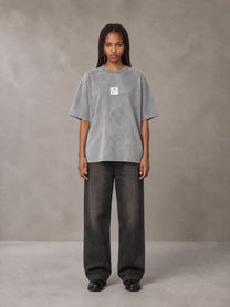 Model wearing the SM Acid Wash T-shirt in Pure Grey, front view.