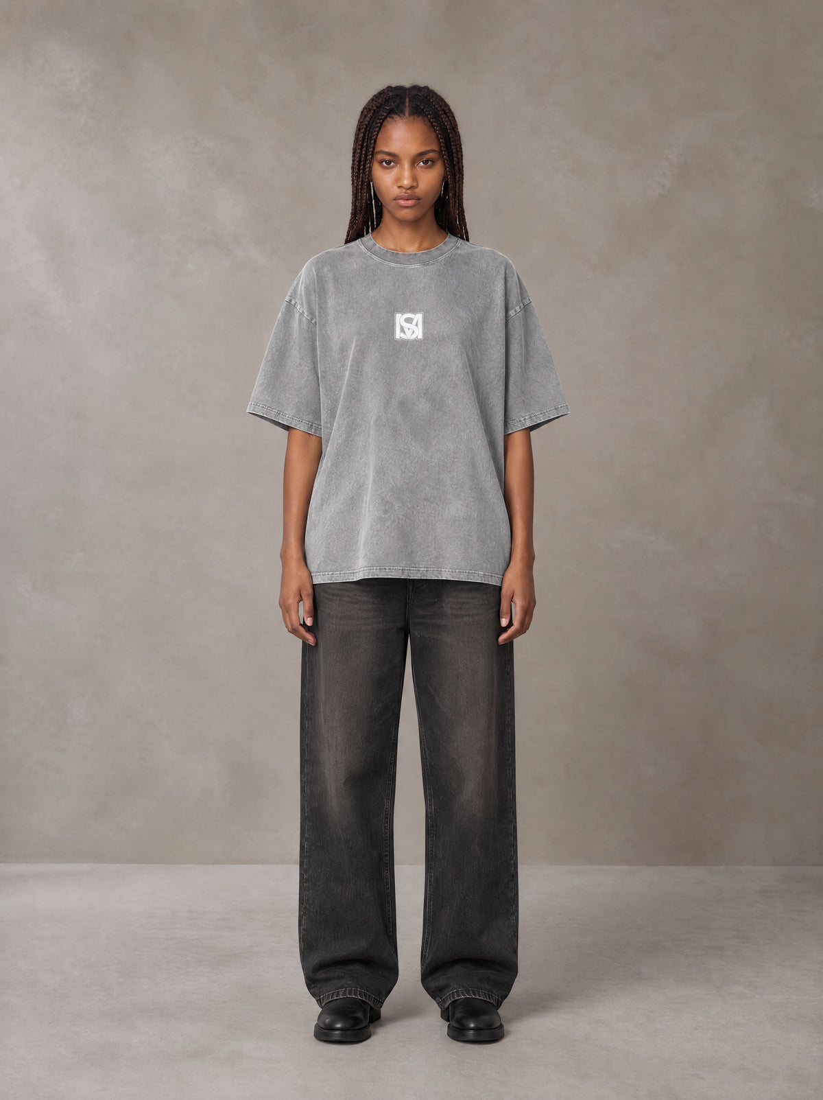 Model wearing the SM Acid Wash T-shirt in Pure Grey, front view.