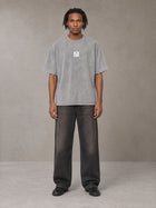 Model wearing the SM Acid Wash T-shirt in Pure Grey, front view.
