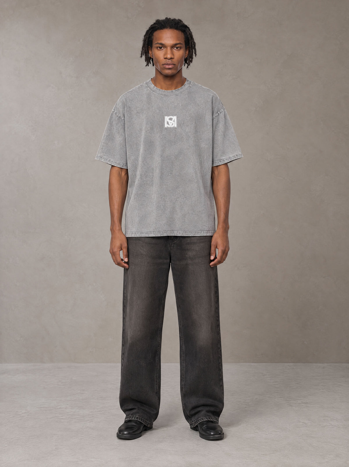 Model wearing the SM Acid Wash T-shirt in Pure Grey, front view.
