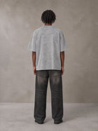 Model wearing the SM Acid Wash T-shirt in Pure Grey, rear view.