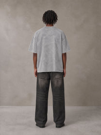 Model wearing the SM Acid Wash T-shirt in Pure Grey, rear view.