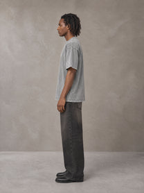 Model wearing the SM Acid Wash T-shirt in Pure Grey, side profile.