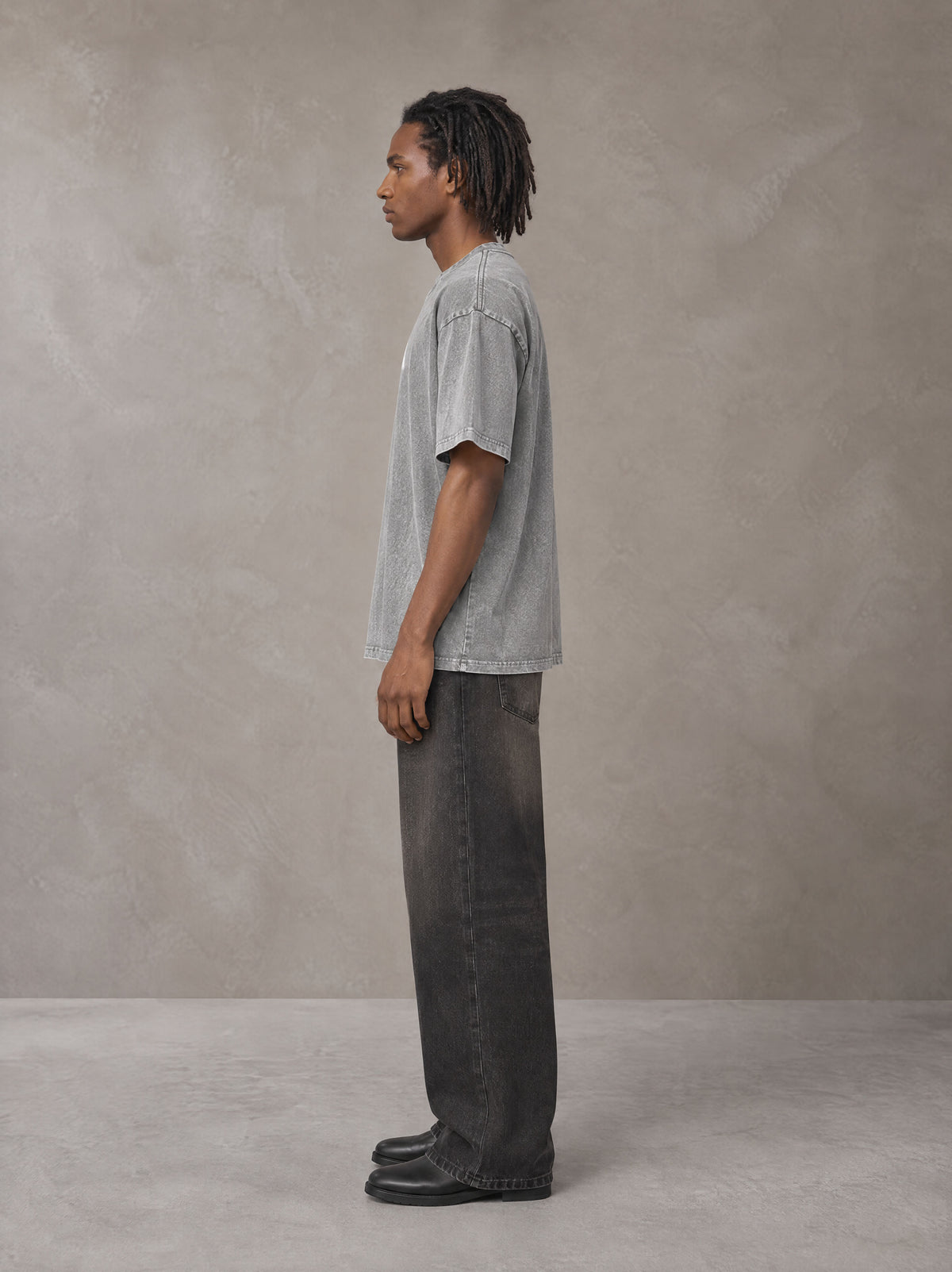 Model wearing the SM Acid Wash T-shirt in Pure Grey, side profile.
